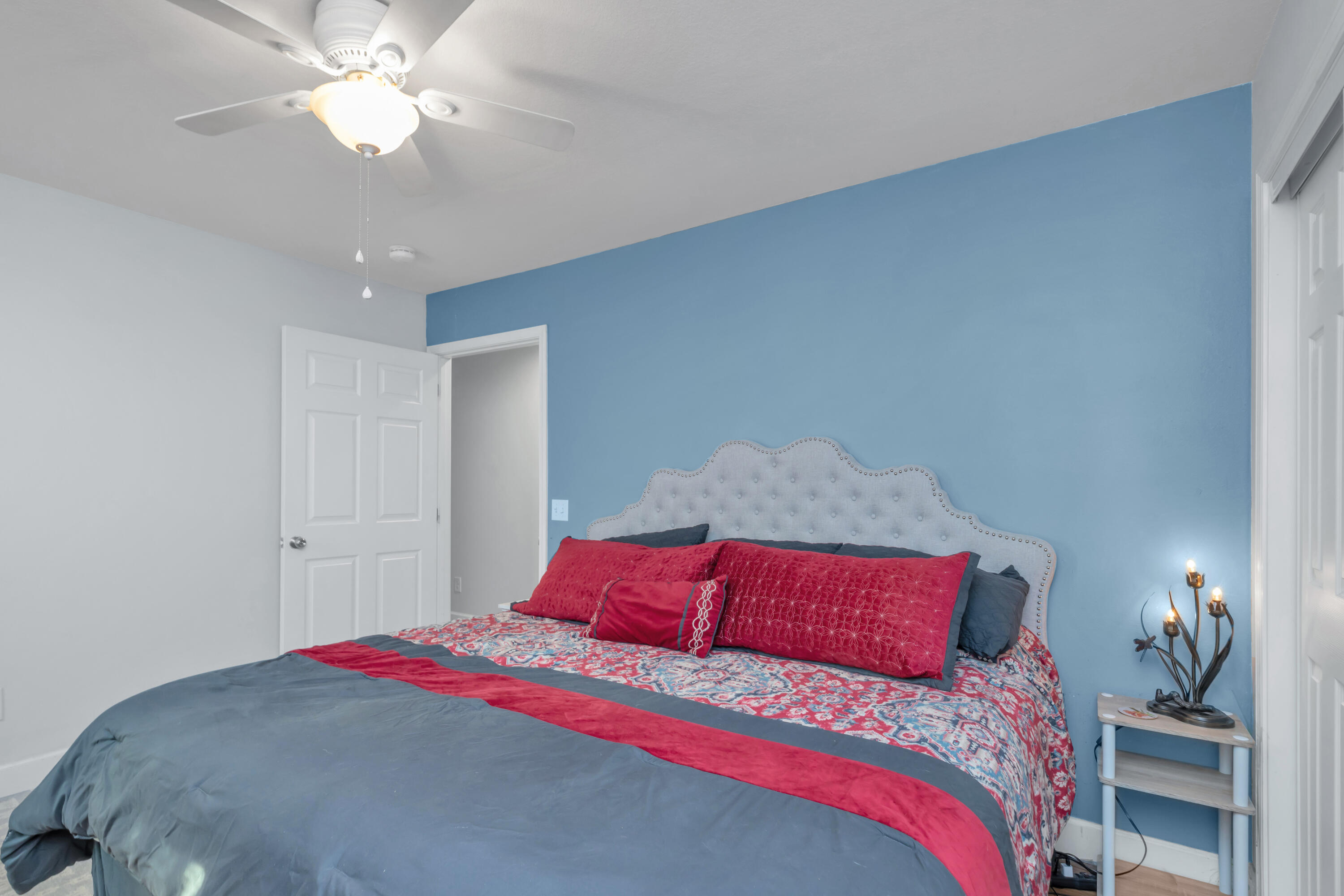 79 6th Street Santa Rosa Beach, FL 32459 - Photo 14 of 42 a bedroom with a bed and a chandelier