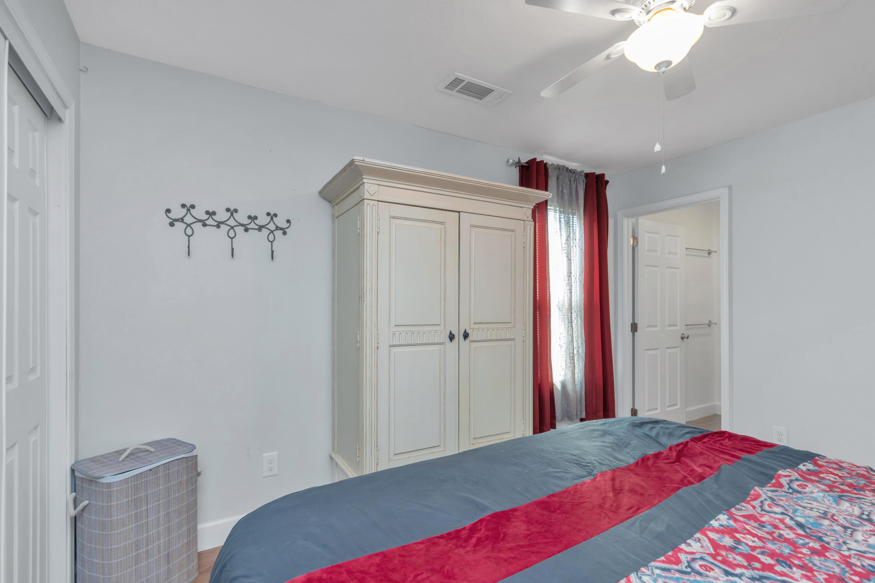 79 6th Street Santa Rosa Beach, FL 32459 - Photo 15 of 42 a bedroom with a bed and a chandelier