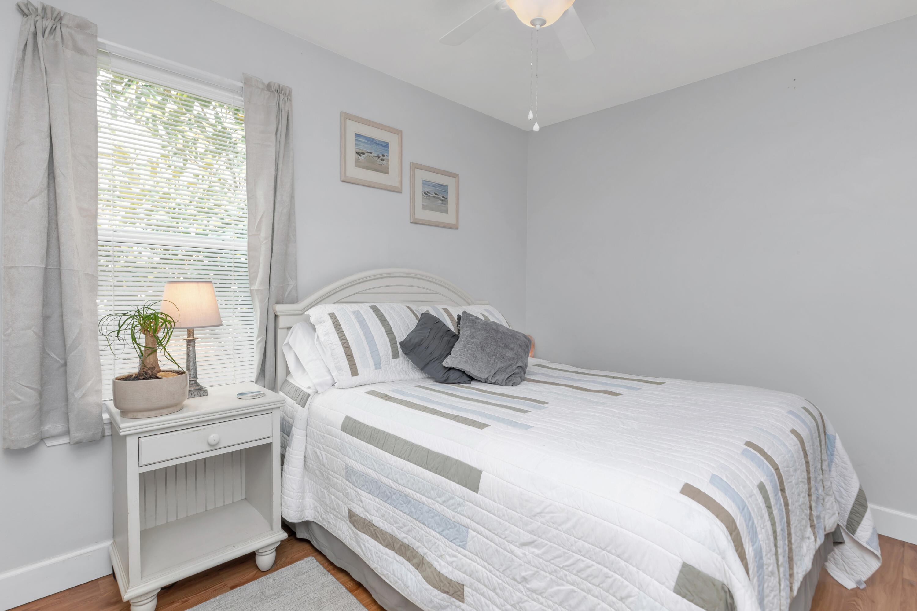 79 6th Street Santa Rosa Beach, FL 32459 - Photo 18 of 42 a bedroom with a bed and a lamp on the dresser