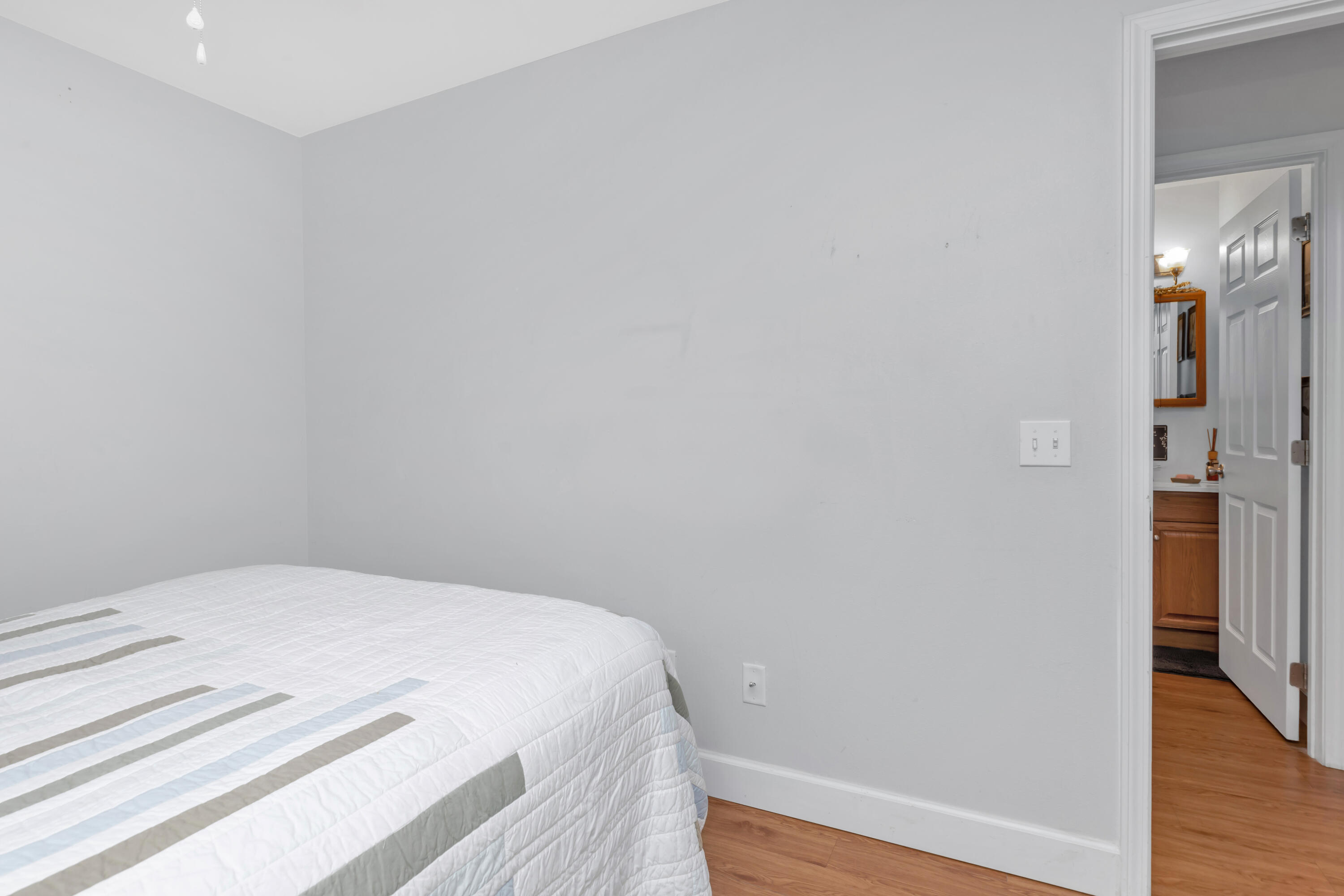 79 6th Street Santa Rosa Beach, FL 32459 - Photo 19 of 42 a bedroom with a bed and wooden floor