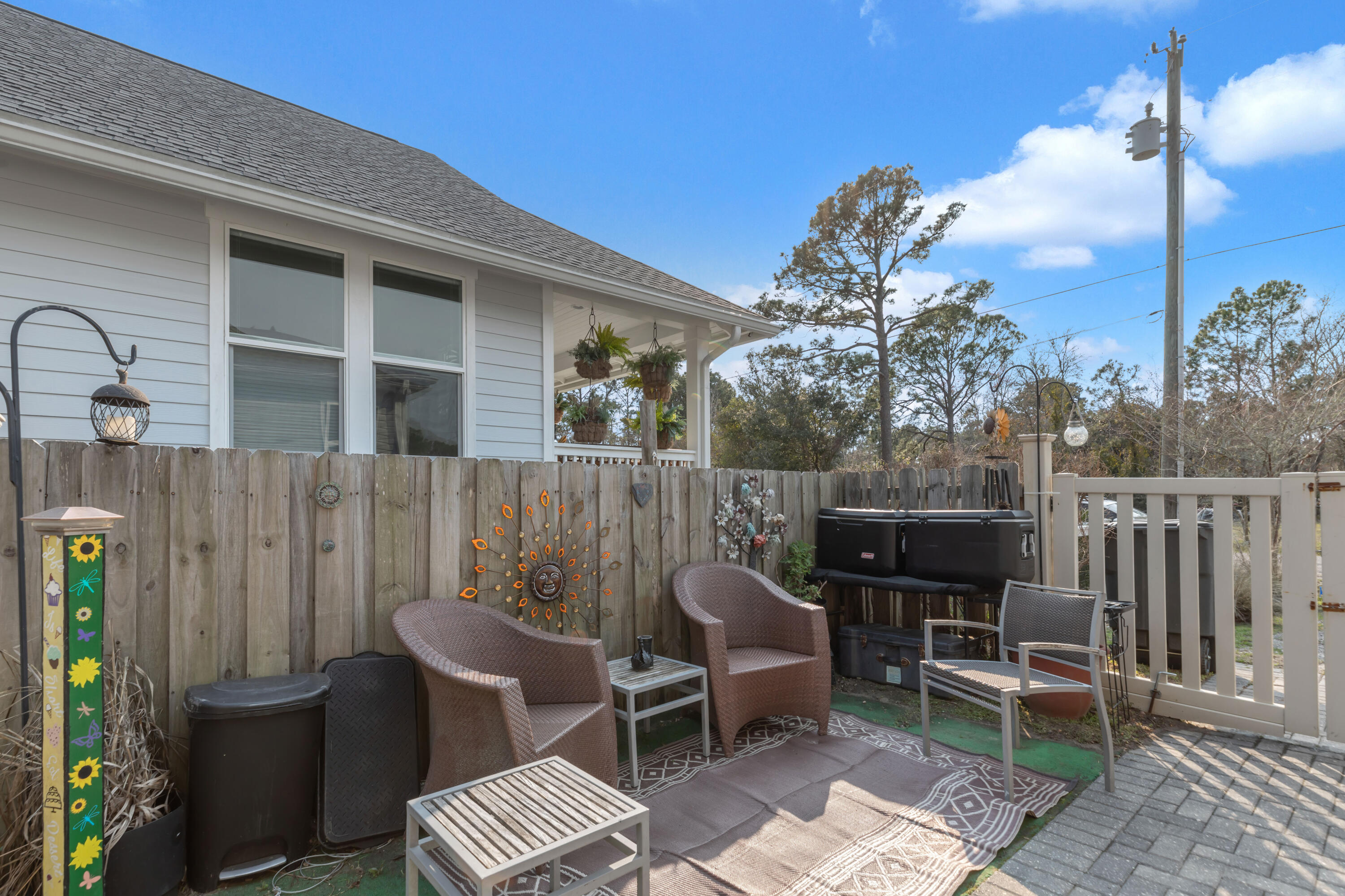 79 6th Street Santa Rosa Beach, FL 32459 - Photo 33 of 42 a view of a chairs and table in the back yard of the house