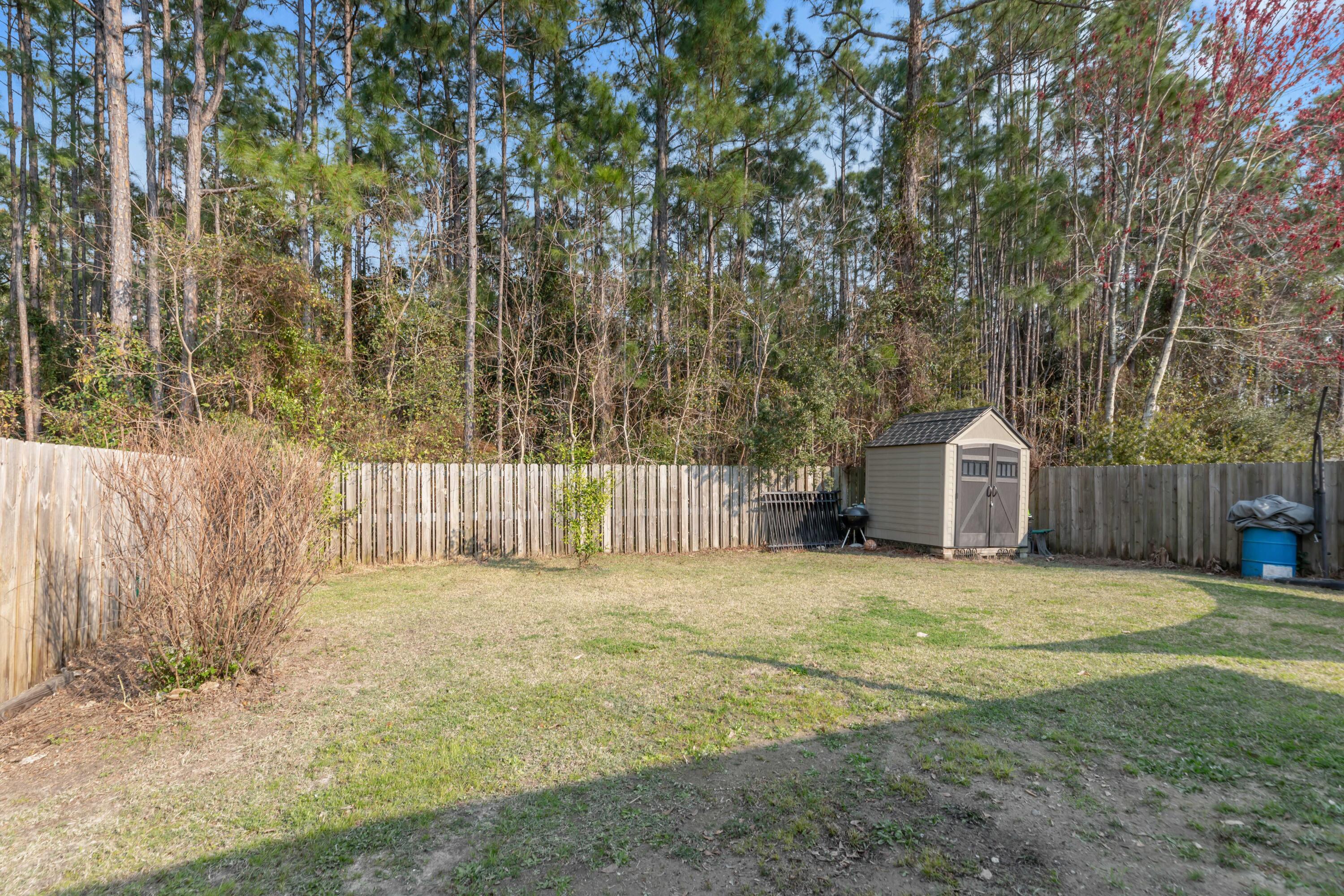 79 6th Street Santa Rosa Beach, FL 32459 - Photo 36 of 42 a front view of a house with a yard and garage