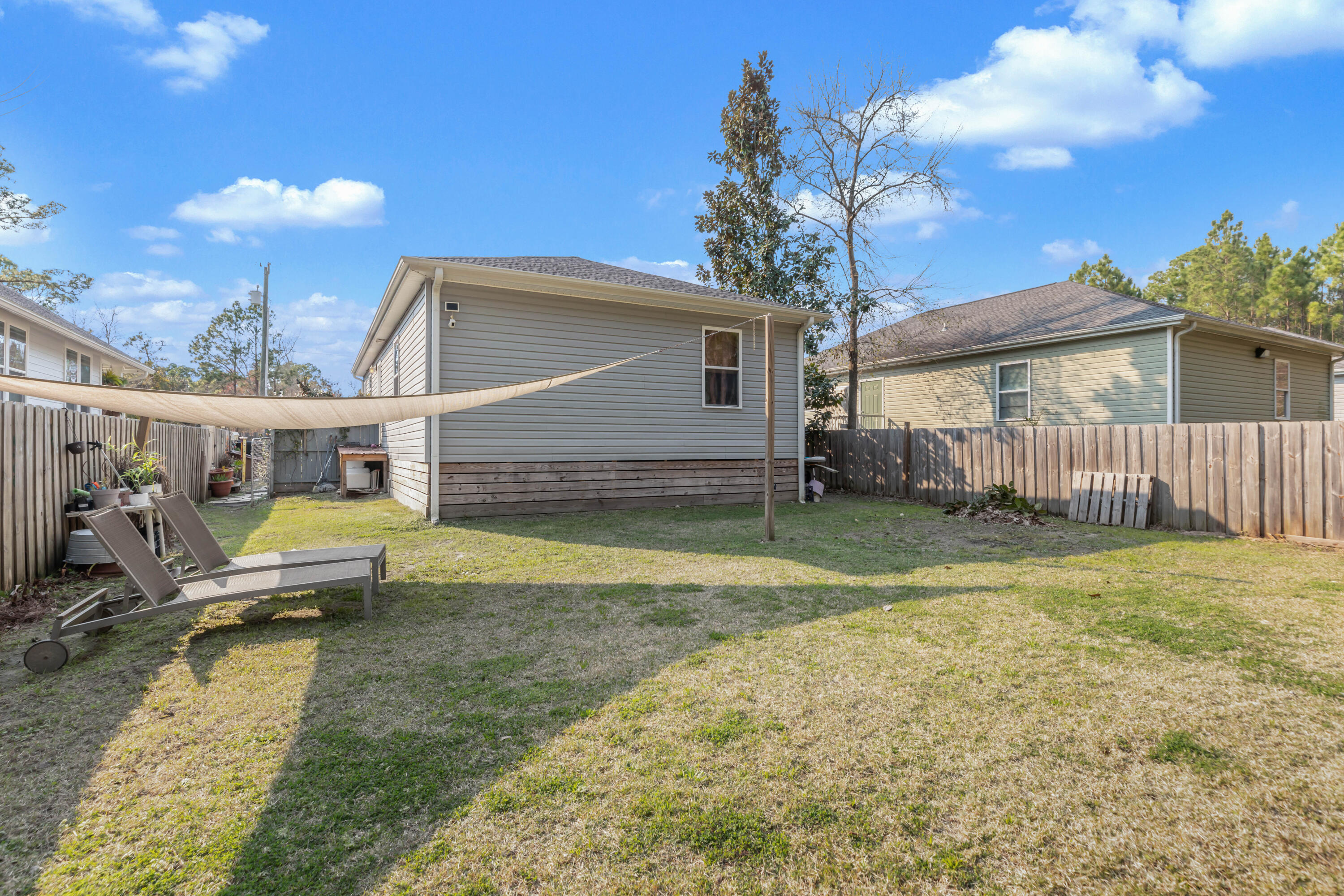 79 6th Street Santa Rosa Beach, FL 32459 - Photo 6 of 42 a view of a house with backyard and sitting area