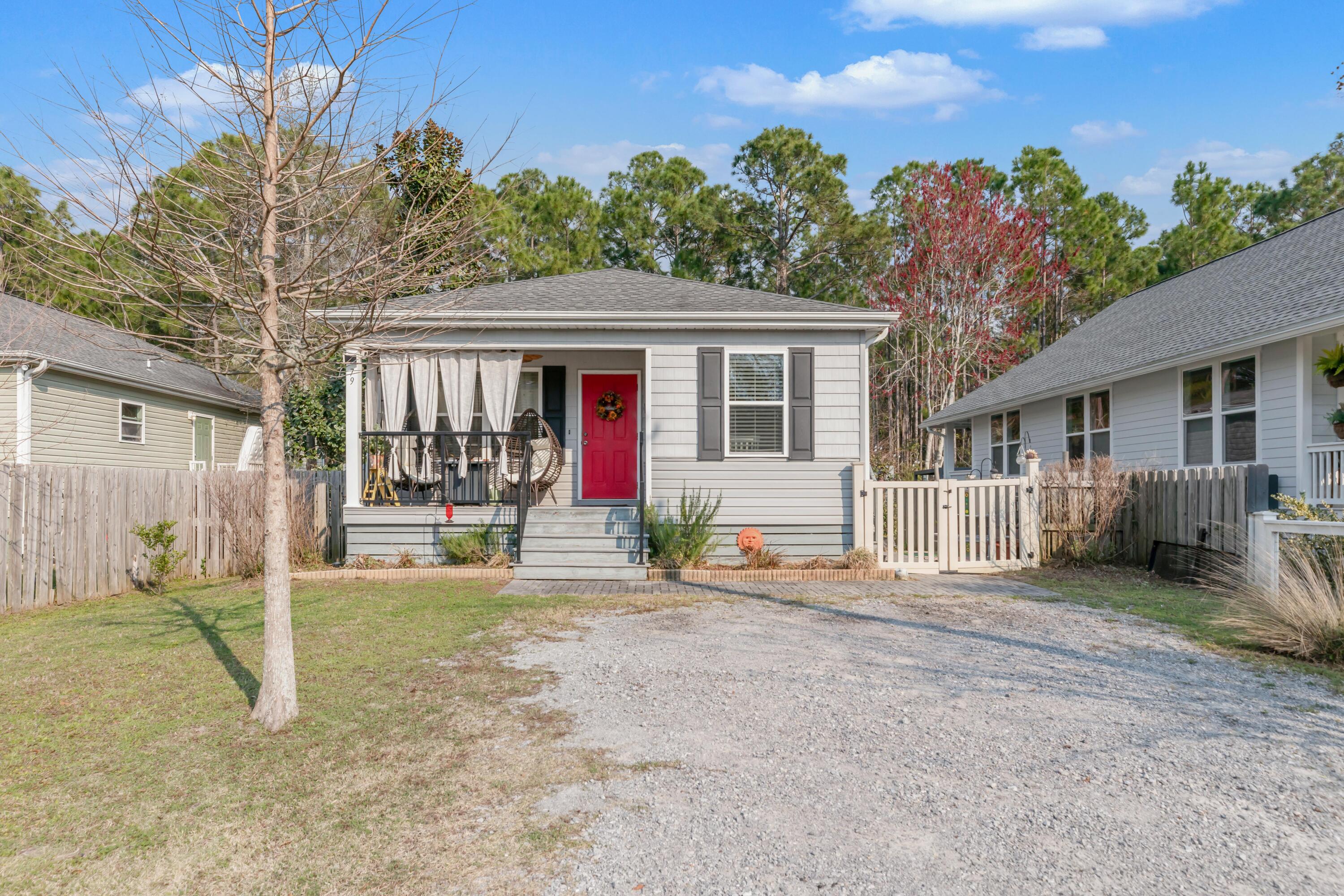 79 6th Street Santa Rosa Beach, FL 32459 - Photo 7 of 42 a backyard of a house with yard and outdoor seating
