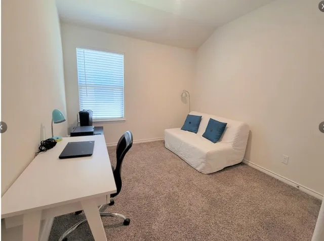 a bedroom with a bed and a chair