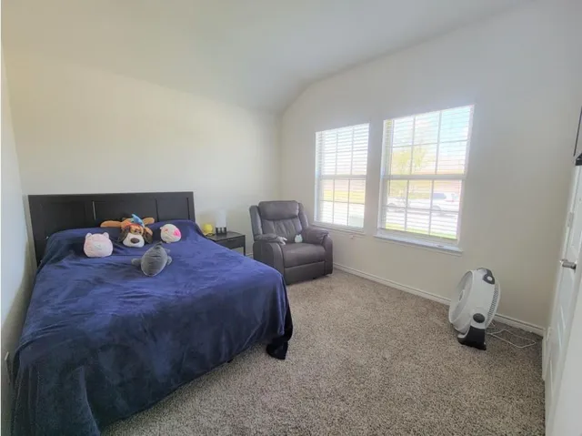 a bed room with a bed and a window