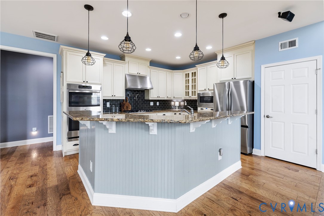 16112 Garston Lane Midlothian, VA 23112 - Photo 13 of 37 a kitchen with stainless steel appliances granite countertop a refrigerator a oven a sink and a island