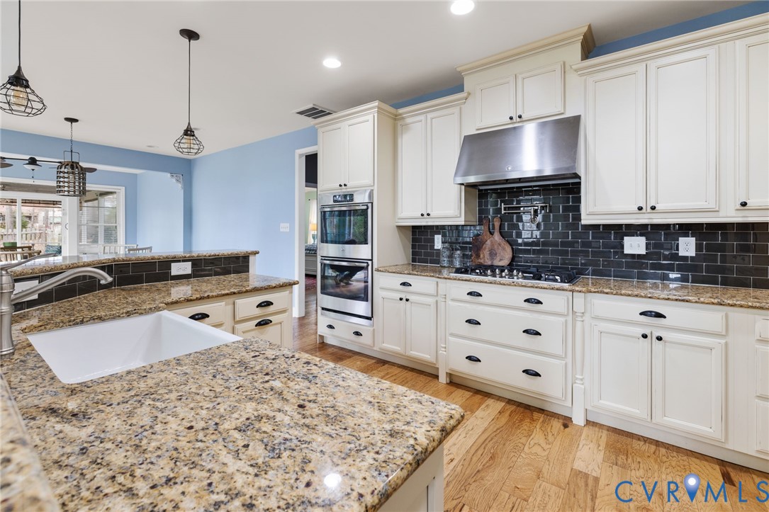 16112 Garston Lane Midlothian, VA 23112 - Photo 14 of 37 a kitchen with granite countertop a sink stove and cabinets