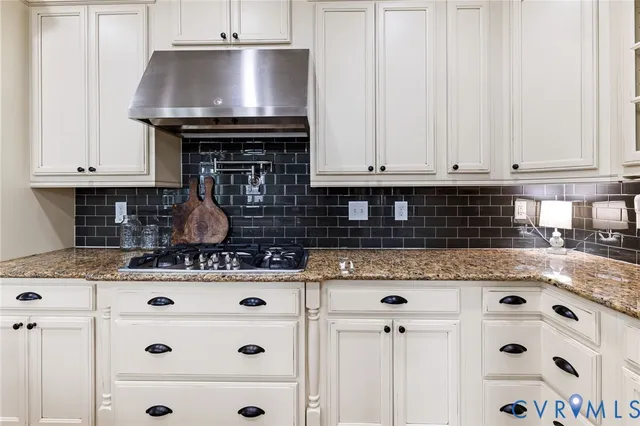 a kitchen with granite countertop a stove a sink and dishwasher