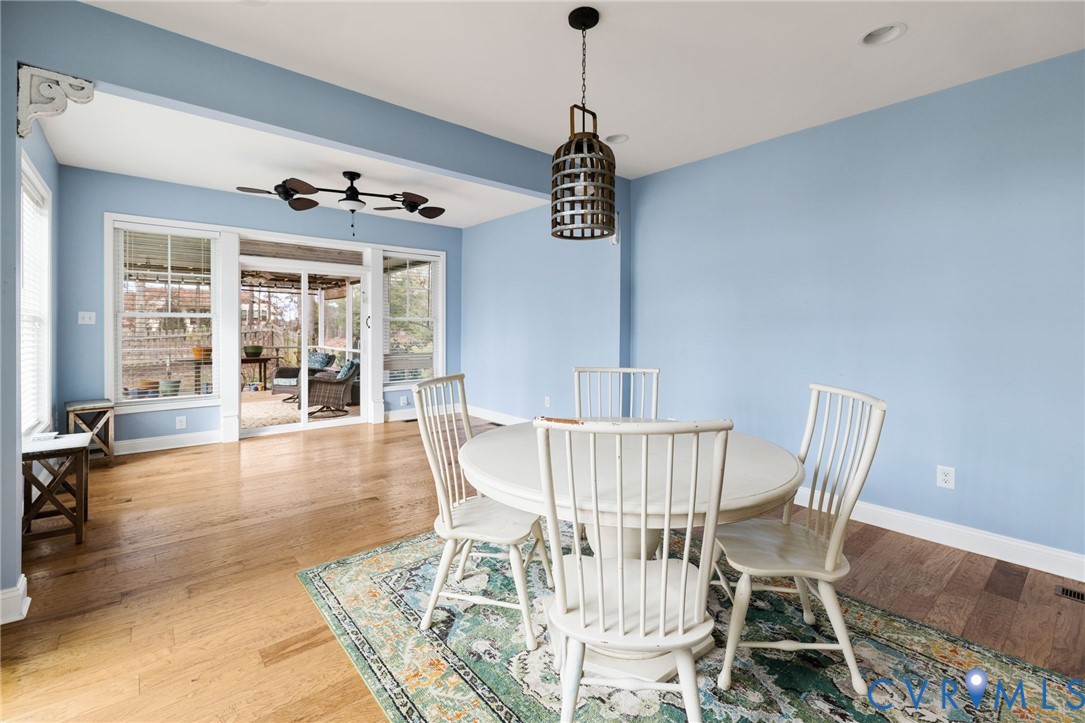 16112 Garston Lane Midlothian, VA 23112 - Photo 17 of 37 a view of a dining room with furniture wooden floor and chandelier