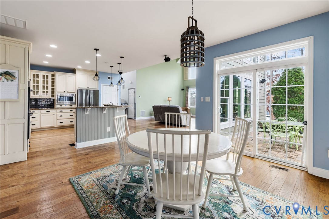 16112 Garston Lane Midlothian, VA 23112 - Photo 19 of 37 a view of a dining room and livingroom with furniture wooden floor a chandelier