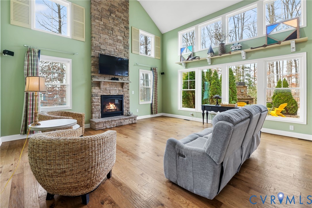 16112 Garston Lane Midlothian, VA 23112 - Photo 2 of 37 a living room with furniture a fireplace and a flat screen tv
