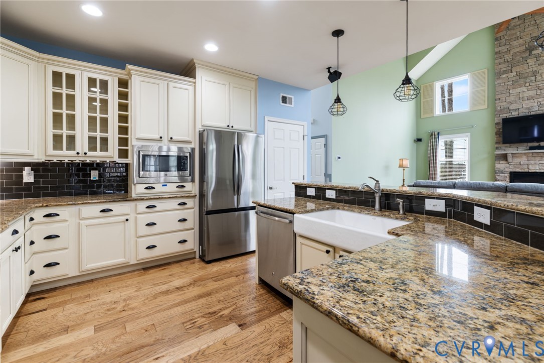 16112 Garston Lane Midlothian, VA 23112 - Photo 3 of 37 a large kitchen with kitchen island a counter top space a sink stainless steel appliances and cabinets