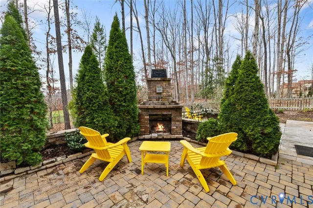 a view of backyard with outdoor seating and plants