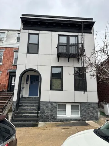 a black and white building with black door