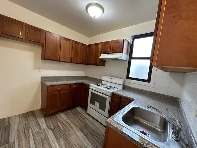 a kitchen with a stove and a sink
