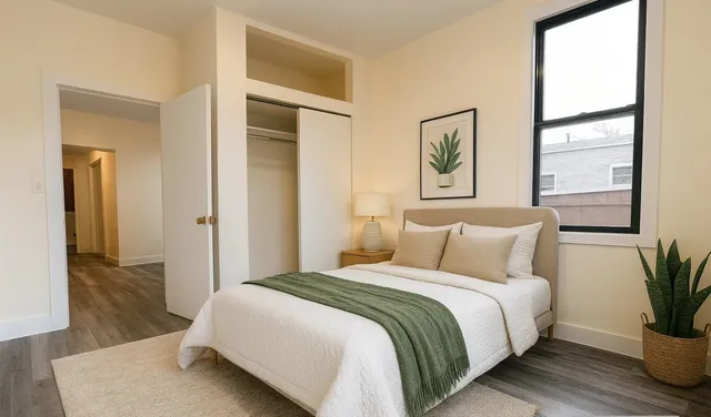 a bedroom with a bed and a painting on the wall