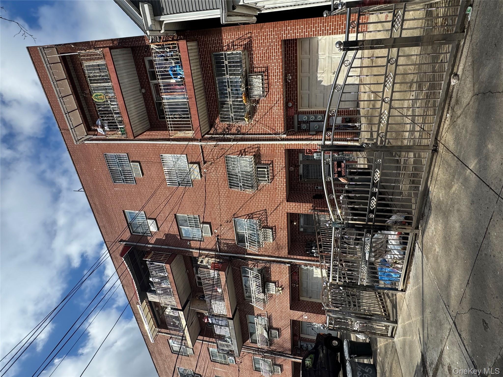 104-37 37th Road Queens, NY 11368 - Photo 3 of 10 a front view of a building with street