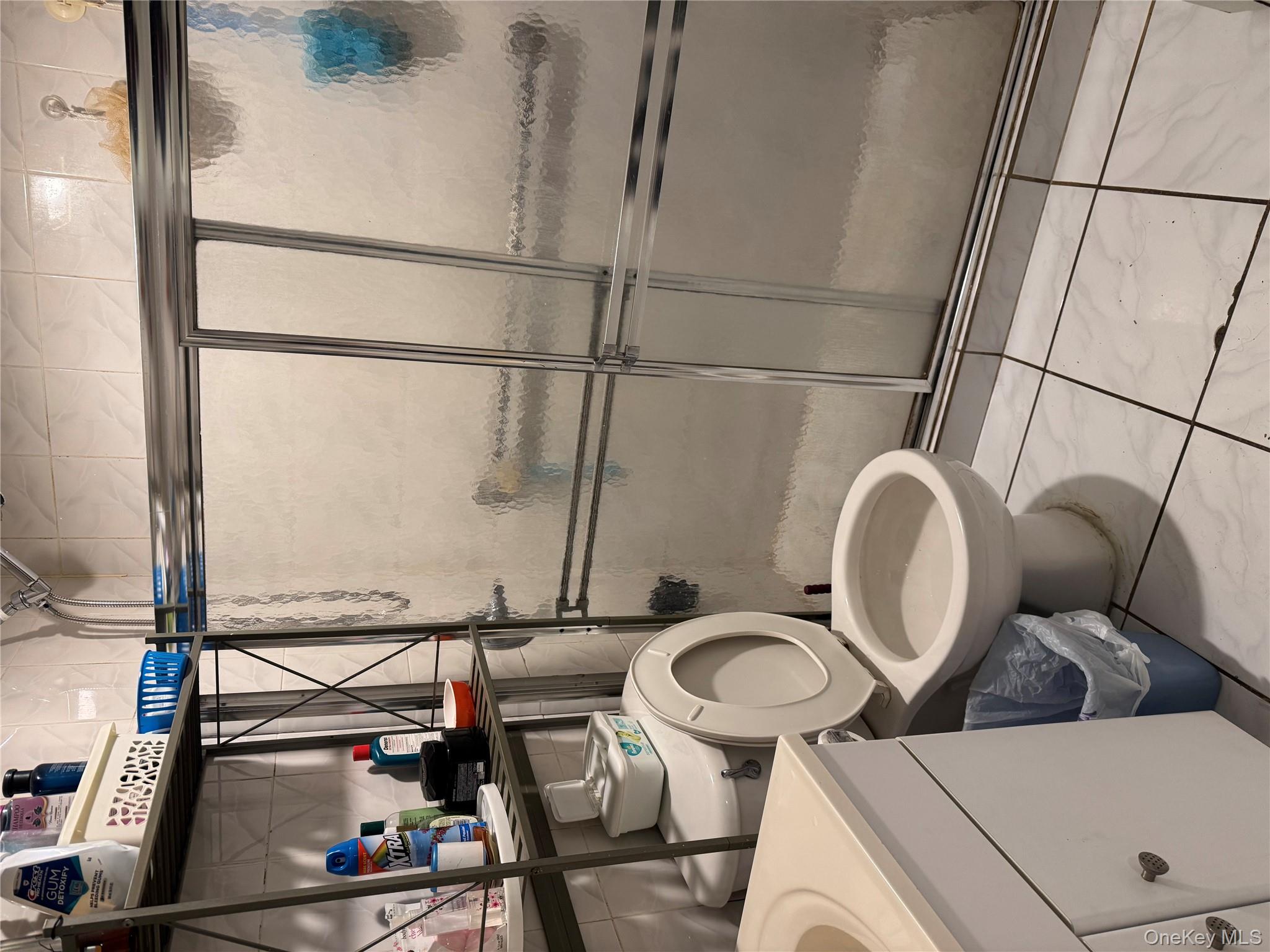 104-37 37th Road Queens, NY 11368 - Photo 5 of 10 a bathroom with a toilet and a sink