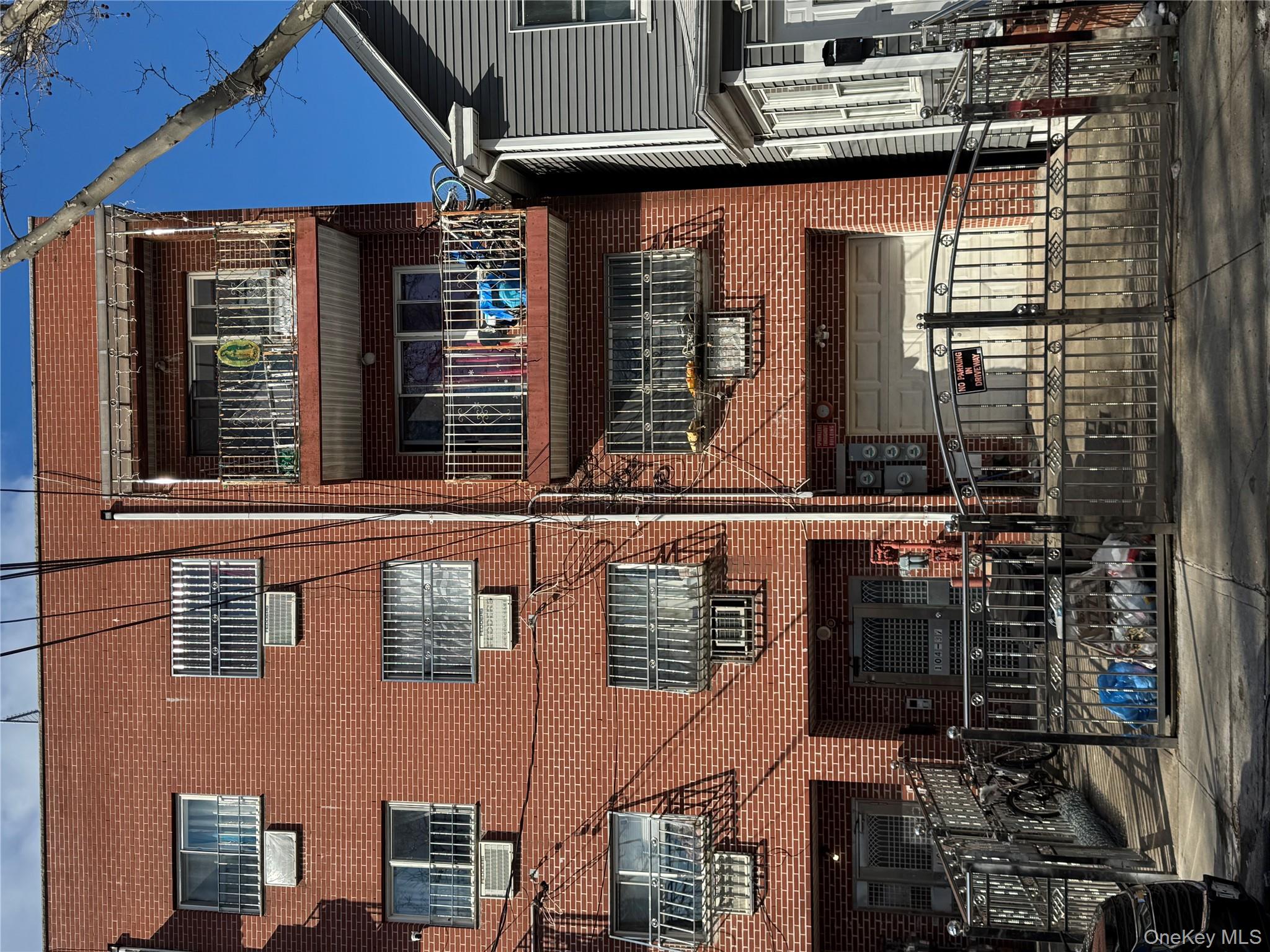 104-37 37th Road Queens, NY 11368 - Photo 10 of 10 a front view of a houses on the street