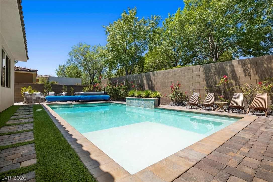 45 Garibaldi Way Henderson, NV 89011 - Photo 35 of 74 A private outdoor oasis, ideal for relaxation and entertaining, offers a refreshing pool with an adjacent patio area.