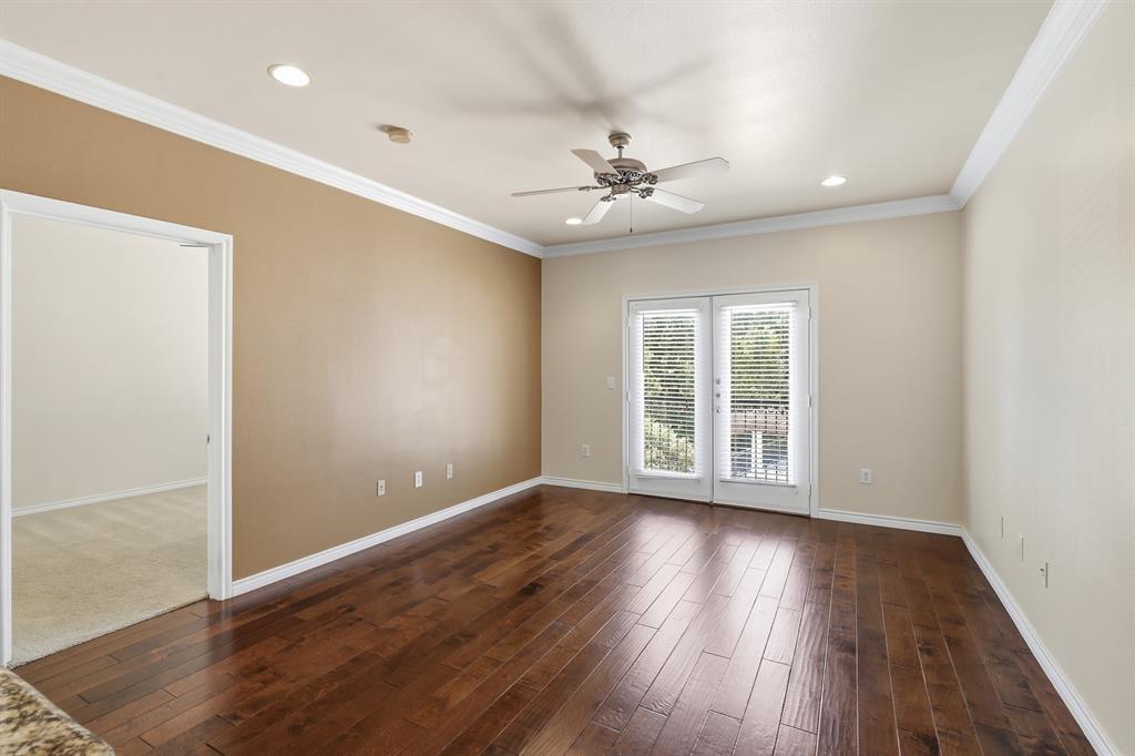 3102 Kings Road, Unit 2212 Dallas, TX 75219 - Photo 9 of 30 a view of an empty room with wooden floor and a window