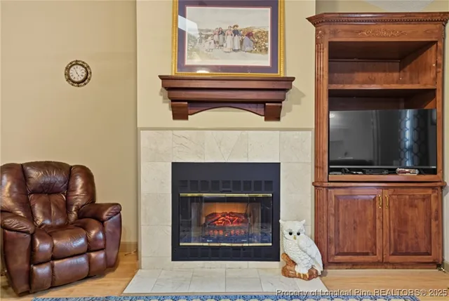 a living room with furniture a flat screen tv and a fireplace
