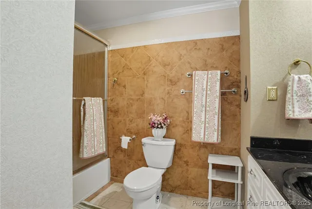 a bathroom with a toilet sink and shower