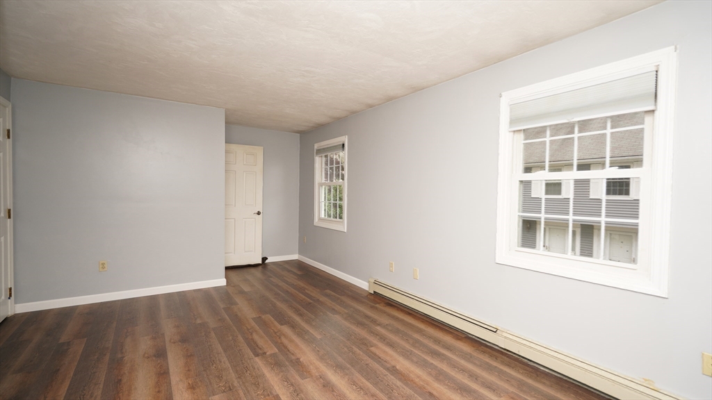 64 Mechanic Street, Unit 3 Attleboro, MA 02703 - Photo 19 of 39 an empty room with wooden floor and windows