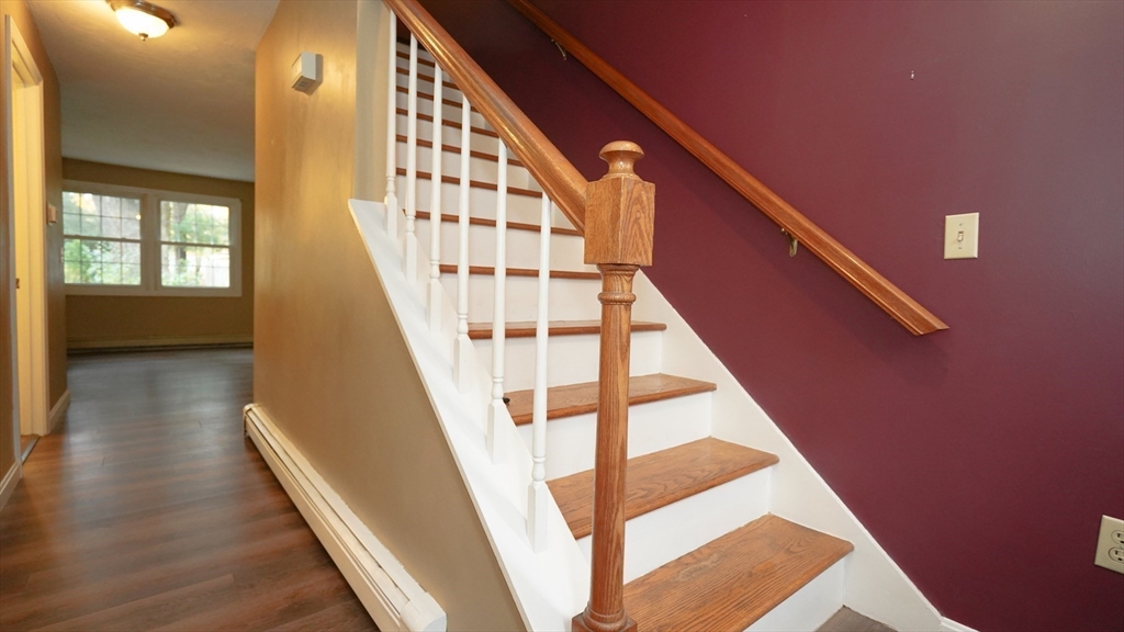 64 Mechanic Street, Unit 3 Attleboro, MA 02703 - Photo 2 of 39 a view of staircase with wooden floor and white walls
