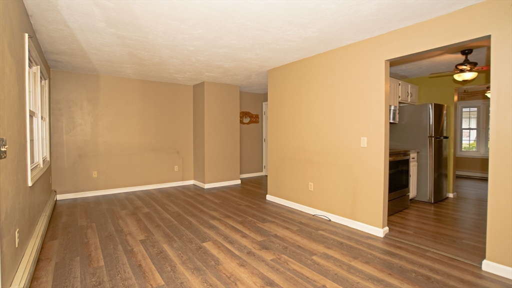 64 Mechanic Street, Unit 3 Attleboro, MA 02703 - Photo 28 of 39 a view of an empty room with wooden floor and a bathroom