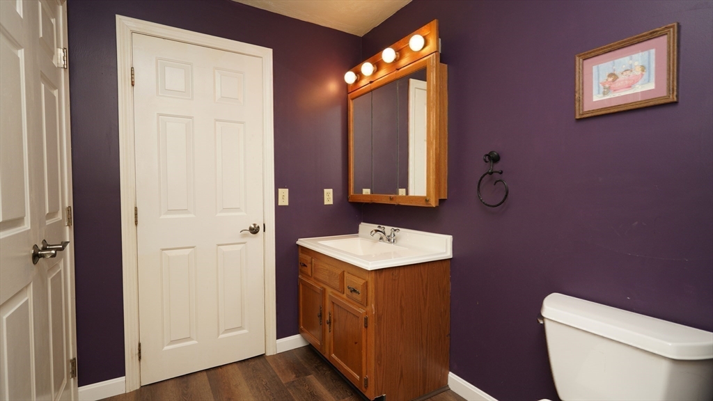 64 Mechanic Street, Unit 3 Attleboro, MA 02703 - Photo 30 of 39 a bathroom with a toilet a sink and mirror