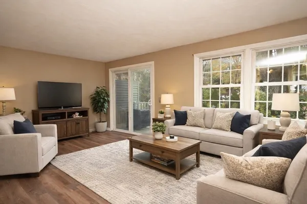 a bedroom with a bed a mirror and dresser with wooden floor