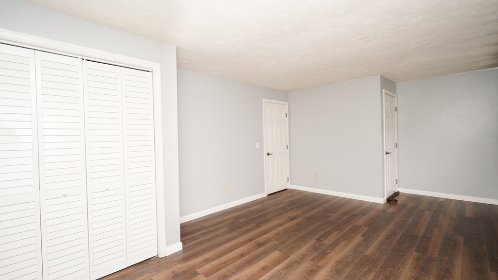 64 Mechanic Street, Unit 3 Attleboro, MA 02703 - Photo 31 of 39 a view of a room with wooden floor and white walls