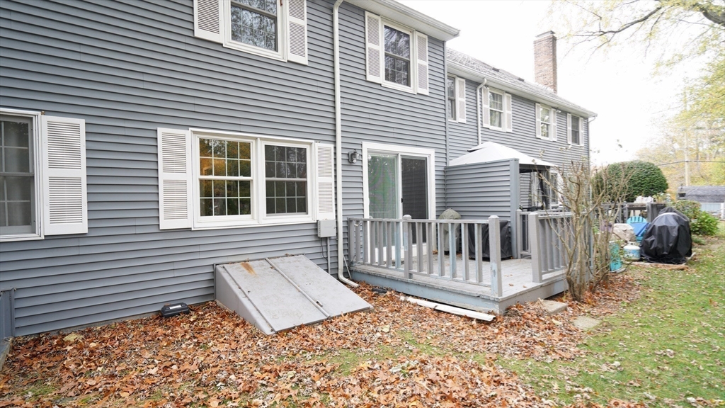 64 Mechanic Street, Unit 3 Attleboro, MA 02703 - Photo 7 of 39 a view of a house with a small yard and wooden fence