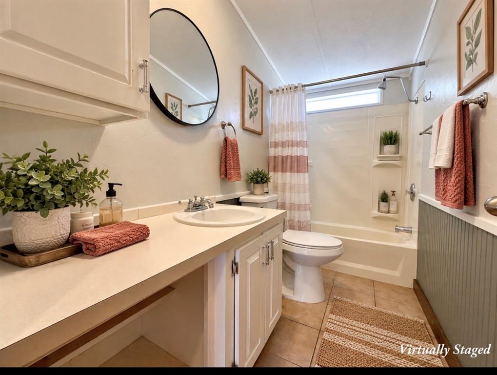 4676 Old Dallas Road Elm Mott, TX 76640 - Photo 11 of 21 Bathroom featuring a white vanity with integrated sink, a white toilet, and a white tub with shower