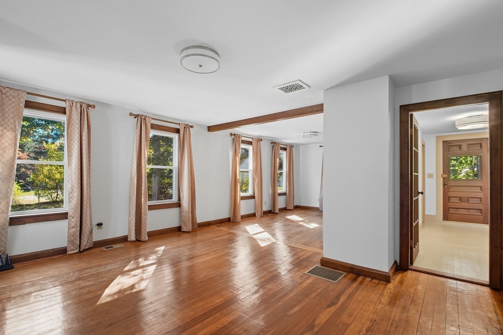 259 Long Plain Road Leverett, MA 01054 - Photo 11 of 39 an empty room with wooden floor and windows