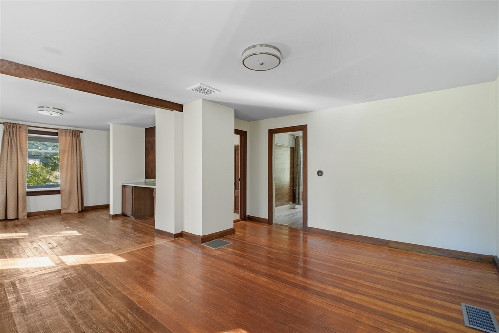 259 Long Plain Road Leverett, MA 01054 - Photo 12 of 39 an empty room with wooden floor and windows