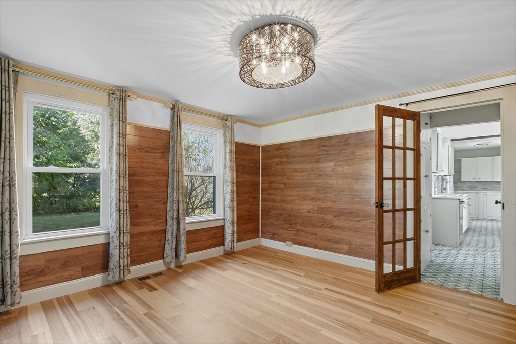 259 Long Plain Road Leverett, MA 01054 - Photo 15 of 39 an empty room with wooden floor mirror and windows