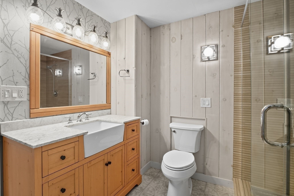 259 Long Plain Road Leverett, MA 01054 - Photo 21 of 39 a bathroom with a granite countertop toilet sink and mirror