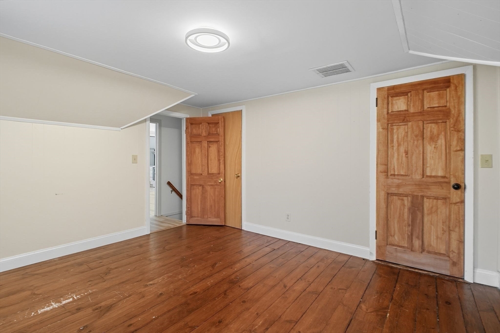 259 Long Plain Road Leverett, MA 01054 - Photo 23 of 39 an empty room with wooden floor and closet area
