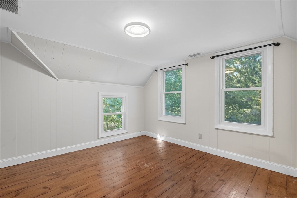 259 Long Plain Road Leverett, MA 01054 - Photo 24 of 39 an empty room with wooden floor and windows