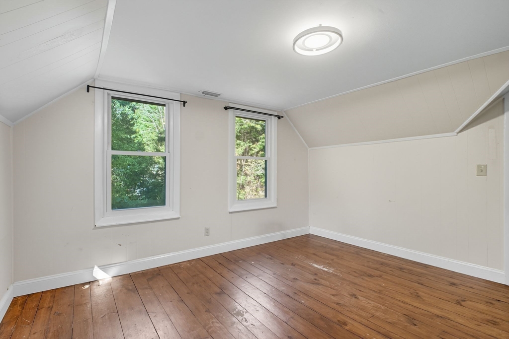259 Long Plain Road Leverett, MA 01054 - Photo 25 of 39 an empty room with wooden floor and windows