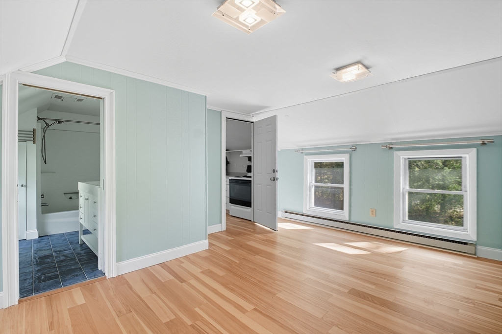 259 Long Plain Road Leverett, MA 01054 - Photo 26 of 39 a view of an empty room with wooden floor and a window
