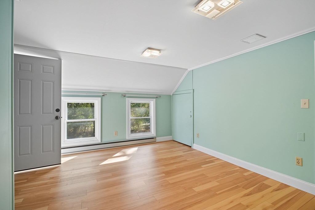 259 Long Plain Road Leverett, MA 01054 - Photo 28 of 39 an empty room with wooden floor and windows