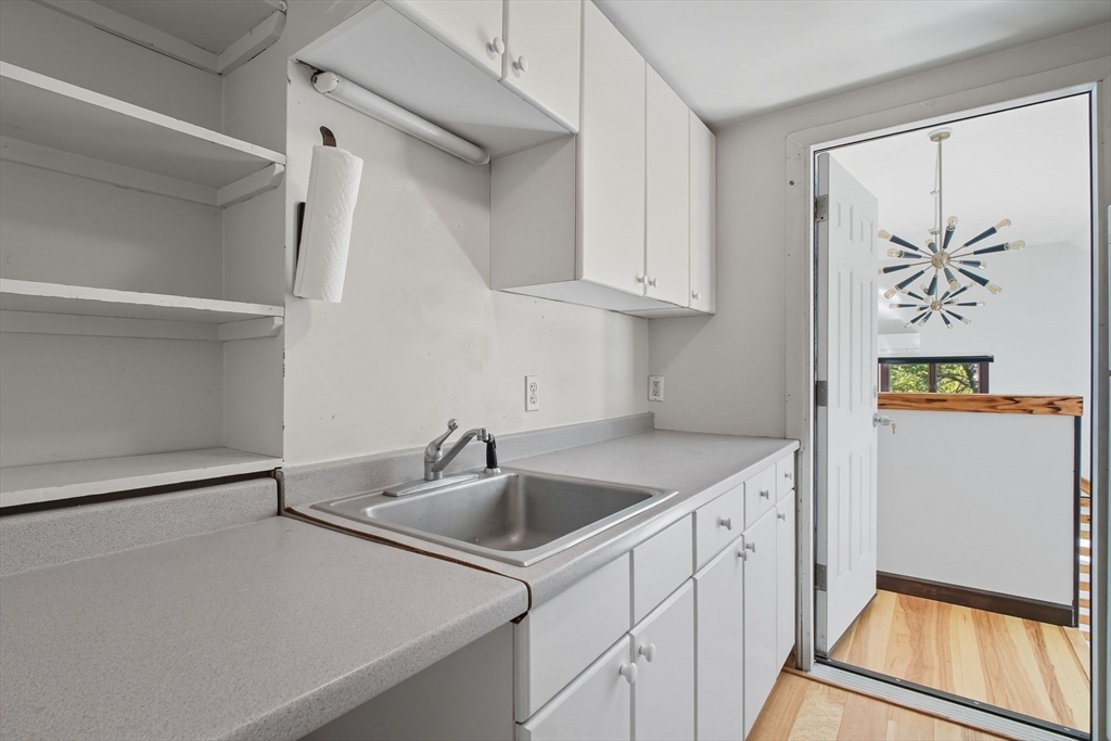 259 Long Plain Road Leverett, MA 01054 - Photo 31 of 39 a kitchen with white cabinets and a sink