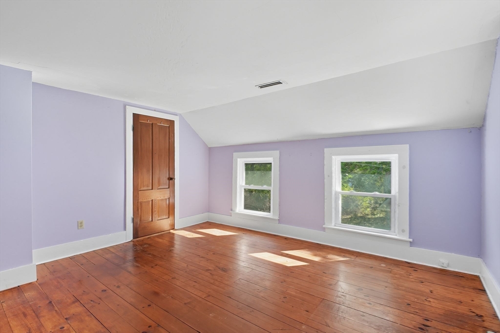 259 Long Plain Road Leverett, MA 01054 - Photo 32 of 39 a view of an empty room with wooden floor and a window