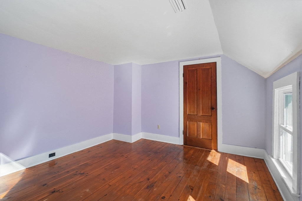 259 Long Plain Road Leverett, MA 01054 - Photo 34 of 39 an empty room with wooden floor and windows