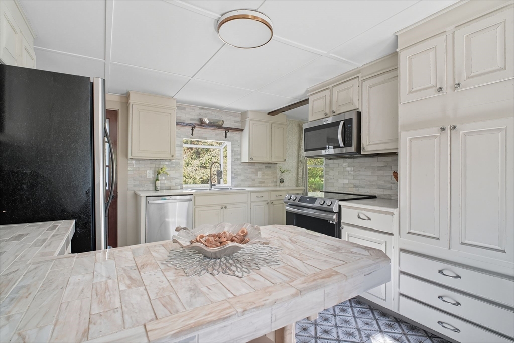 259 Long Plain Road Leverett, MA 01054 - Photo 5 of 39 a kitchen with a refrigerator stove and white cabinets