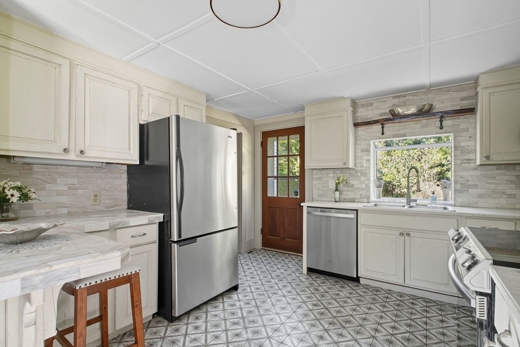 259 Long Plain Road Leverett, MA 01054 - Photo 6 of 39 a kitchen with a refrigerator a stove a sink and a window